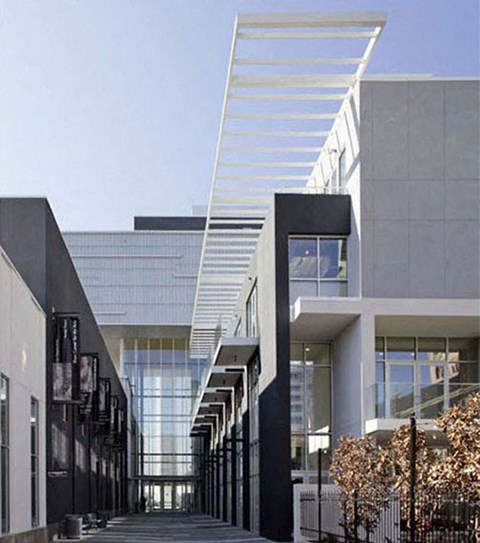 a view of the outside of a building with a long walkway