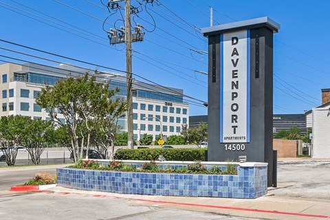 a sign that says davenport with a building in the background