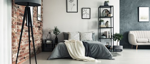 grey apartment with king sized bed and sofa